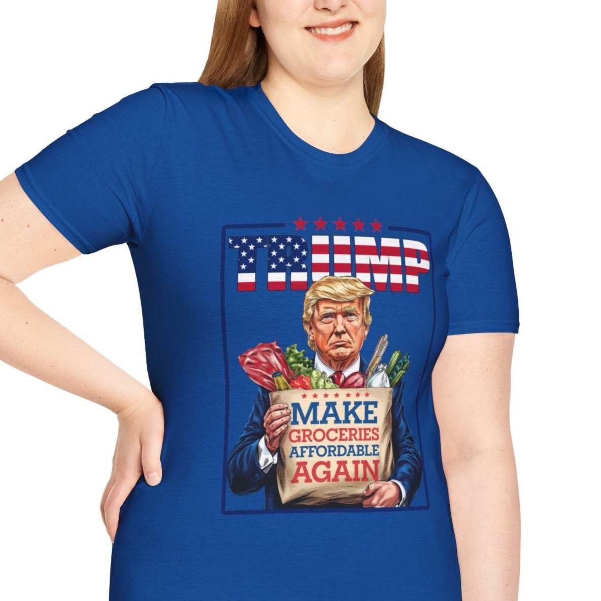 Blue Trump 2024 t-shirt with "Make Groceries Affordable Again" design, featuring Trump holding groceries, worn by a smiling supporter.