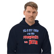Man wearing a cozy navy blue hoodie with "I'm Just Here for the Fireworks and Beer" text, perfect for cooler evenings.