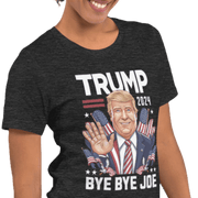 Woman wearing Trump 2024 Bye Bye Joe funny tee with illustration of President Trump waving and American flag motifs.