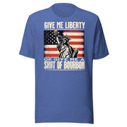 T-shirt with Give Me Liberty or Give Me a Shot of Bourbon text, Statue of Liberty holding a shot glass, and distressed American flag background. Perfect for 4th of July.