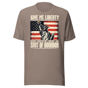 T-shirt with Give Me Liberty or Give Me a Shot of Bourbon text, Statue of Liberty holding a shot glass, and distressed American flag background. Perfect for 4th of July.