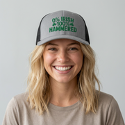 a woman wearing a gray and black curved trucker hat with the phrase '0% Irish 100% HAMMERED' funny St Patricks Day Pub crawl and Parade design