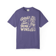 A purple short-sleeve crewneck t-shirt with a cream-colored graphic on the front that reads 'Ghouls Just Wanna Drink Wine' alongside a skeleton illustration, shown against a plain white background.