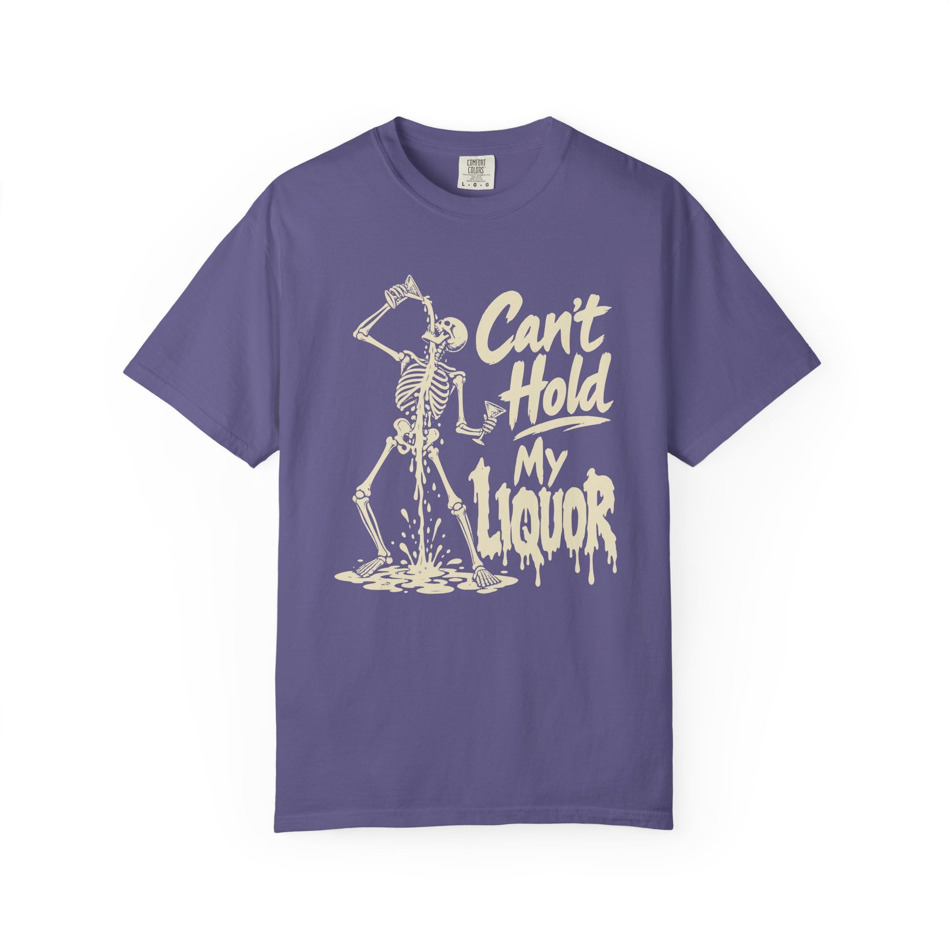 A purple short-sleeve crewneck t-shirt featuring a cream-colored graphic of a skeleton dancing and holding a glass, next to the text 'Can't Hold My Liquor' in a dripping font.