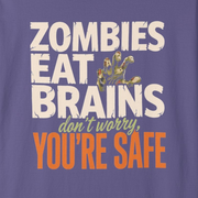 A purple short-sleeve crewneck t-shirt with a graphic text print on the front reading 'ZOMBIES EAT BRAINS don't worry YOU'RE SAFE' in white, yellow, and orange lettering, displayed on a clean white background.