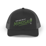 a black and charcoal curved bill trucker hat with the phrase'You Had Me at Mimosas' text funny Spring break, girls trip, guys trip, beach trip, summer vacation, lake season design