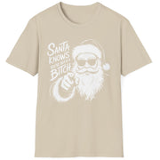 Funny Christmas Humor Short Sleeve Shirt with Santa pointing and the text "Santa Knows You've Been a Bitch" - Sand