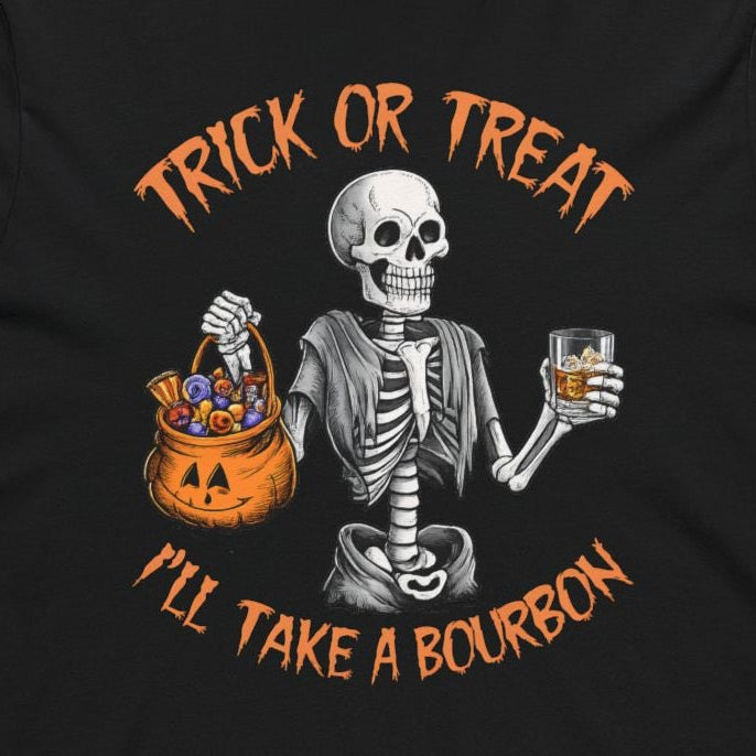 A black long-sleeve hoodie with a Halloween-themed graphic on the chest. The graphic features a white skeleton holding a glass of whiskey next to a jack-o'-lantern bucket, with orange text reading 'TRICK OR TREAT I'LL TAKE A BOURBON'.
