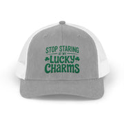 a gray and white curved trucker hat with the phrase Stop Staring at My Lucky Charms funny St Patricks Day pub crawl or parade design