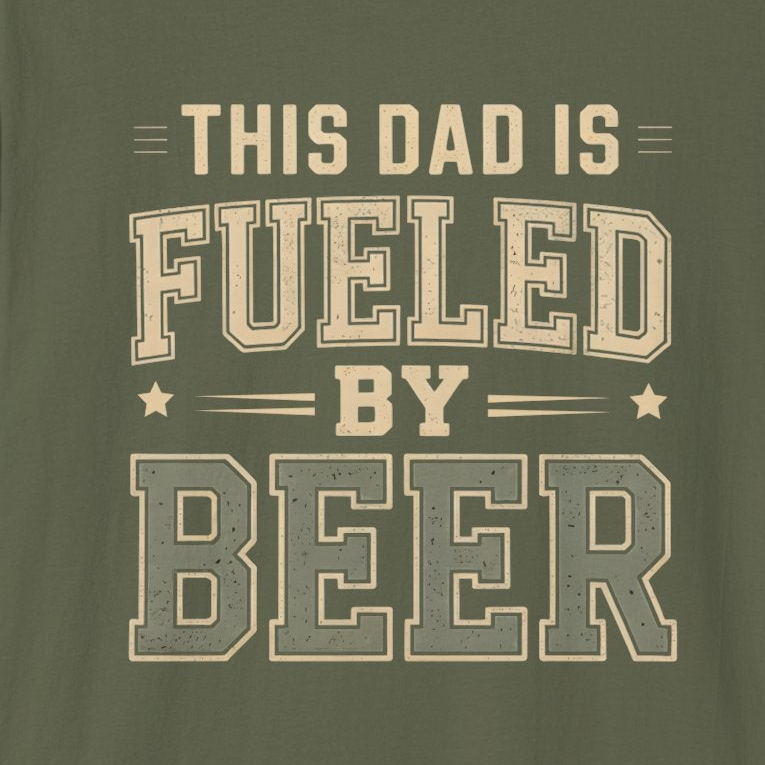 Green t-shirt with beige text 'This Dad is Fueled by Beer' on a solid background