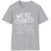 Funny Christmas Short Sleeve Shirt with a gingerbread man holding the oven door open with a sheet pan of gingerbread cookies and the text "We're Cooked" - Sport Grey