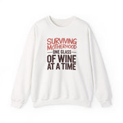 a white sweatshirt with the phrase 'Surviving Motherhood One Glass of Wine at a Time' funny mother's day, mom life, girls trip design