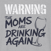 a gray t-shirt with the text 'Warning:the moms are drinking again' funny mother's day, beach trip, girls trip design