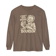 A brown long-sleeve t-shirt with a vintage-style graphic of a zombie holding a glass of bourbon, accompanied by the text 'I DON'T NEED BRAINS I HAVE BOURBON' in a cream-colored distressed font, shown on a plain white background.