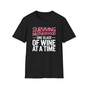 a black t-shirt with the phrase 'Surviving Motherhood One Glass of Wine at a Time' funny Mother's day, beach vacation, spring break design
