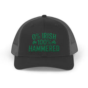 A black and gray curved trucker hat with the phrase '0% Irish 100% HAMMERED' funny St Patricks Day Pub crawl and Parade design