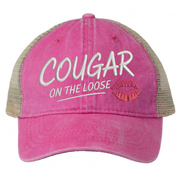 a bright pink and khaki faded ponytail trucker cap with 'Cougar on the Loose' text and lipstick kiss mark funny spring break, beach vacation, summer vacation, lake season design.
