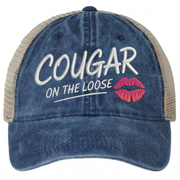 a navy and khaki faded ponytail trucker cap with 'Cougar on the Loose' text and lipstick kiss mark funny spring break, beach vacation, summer vacation, lake season design.