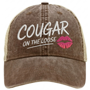a brown and khaki faded ponytail trucker cap with 'Cougar on the Loose' text and lipstick kiss mark funny spring break, beach vacation, summer vacation, lake season design.