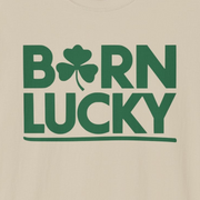 beige t-shirt with 'Born Lucky' text and clover funny st patricks day design