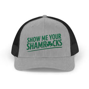 a grey and black curved trucker hat with 'Show Me Your Shamrocks' text funny st patricks day pub crawl design