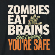 A black long-sleeve t-shirt with a graphic print on the front that reads 'ZOMBIES EAT BRAINS don't worry, YOU'RE SAFE' in distressed white, green, and orange lettering, shown against a plain white background.