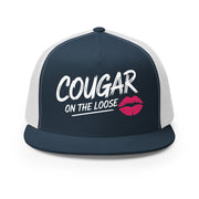 a navy and white flat bill trucker hat with the phrase 'Cougar on the Loose' funny beach trip, girls trip, bachelorette party, or spring break design