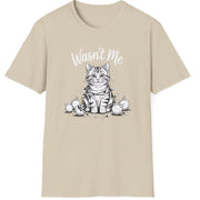 Funny Christmas Cat Humor Short Sleeve Shirt with a cute cat wrapped in christmas lights and surrounded by broken ornaments and the text "Wasn't Me" - Sand