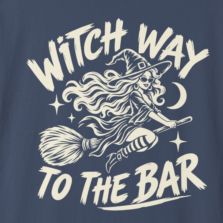 A navy blue short-sleeve crewneck t-shirt with a cream-colored graphic on the front showing a witch riding a broomstick with the text 'WITCH WAY TO THE BAR'.
