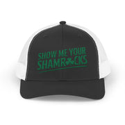 a black and white curved trucker hat with 'Show Me Your Shamrocks' text funny st patricks day pub crawl design