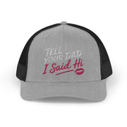 a gray and black curved trucker hat with the phrase "Tell Your Dad I said Hi" and lipstick kiss mark funny Spring Break, Girls Trip, Bachelorette Party, Beach Trip, or Summer Vacation design