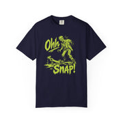 A navy blue short-sleeve t-shirt with a bright yellow-green graphic on the front showing a zombie and the text 'Ohh SNAP!'.