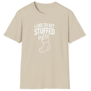 Funny Christmas Humor Short Sleeve Shirt with a stocking stuffed with presents and the text "I Like to get Stuffed" - Sand