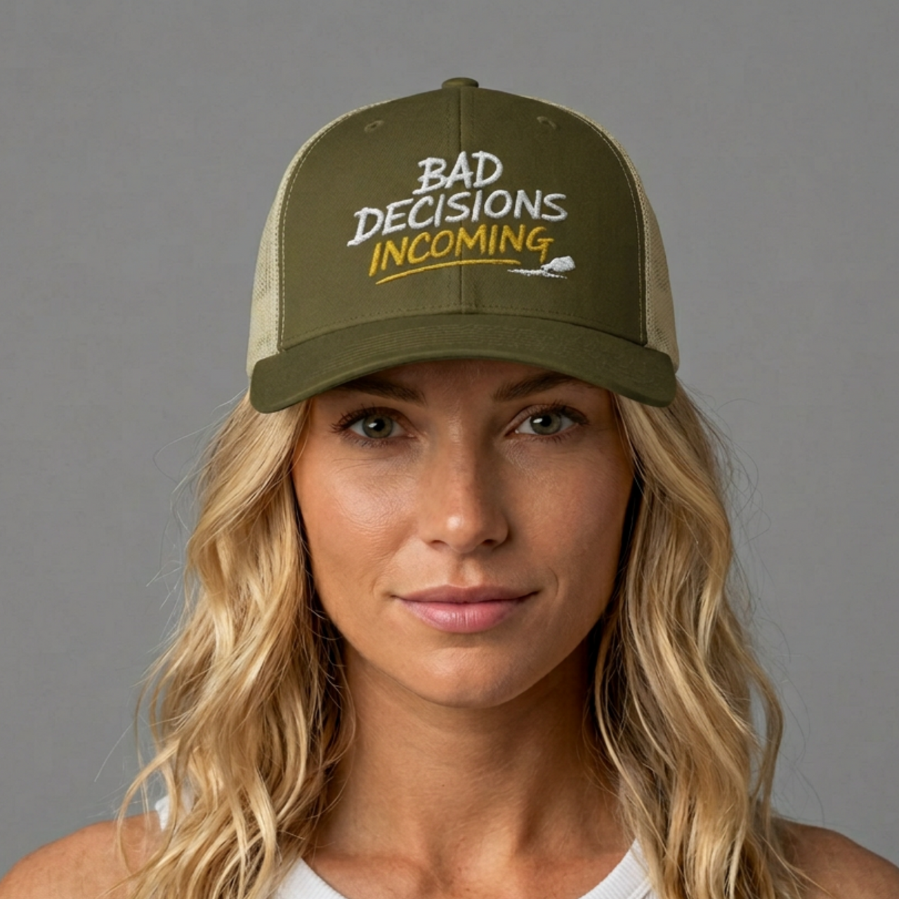 Woman wearing a green and tan curved trucker hat with embroidered text 'Bad Decisions Incoming'  funny Spring Break, Girls rips, Guys Trips, Beach Trips, Bachelor or Bachelorette design