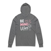Gray hoodie with the phrase "Be Mine". Mine is crossed out and Wine is written underneath. minimalist wine glass and heart graphics complete the design