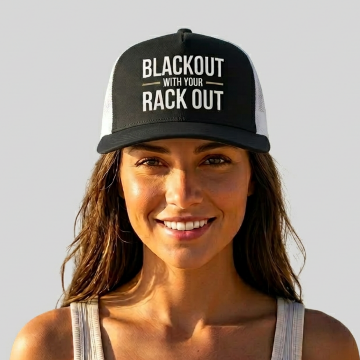 woman wearing a black and whit premium flat bill trucker hat with the phrase 'Blackout with your Rack Out" funny spring break, beach vacation, girls trip, bachelorette party design