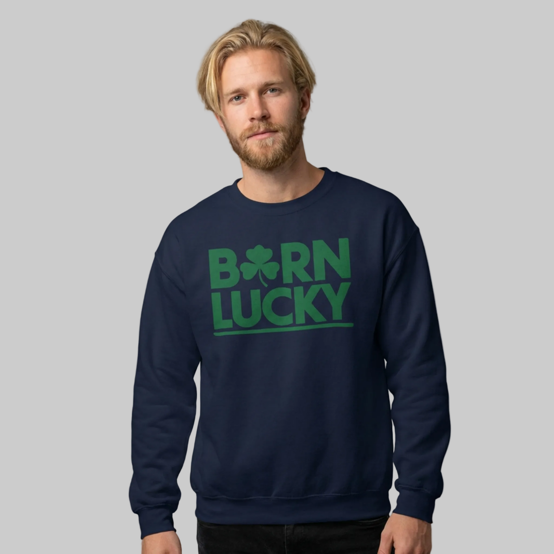 Man wearing a navy blue sweatshirt with 'Born Lucky' text and green clover funny st patricks design
