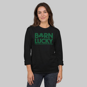 Woman wearing a black long-sleeve shirt with 'Born Lucky' text funny st patricks day design