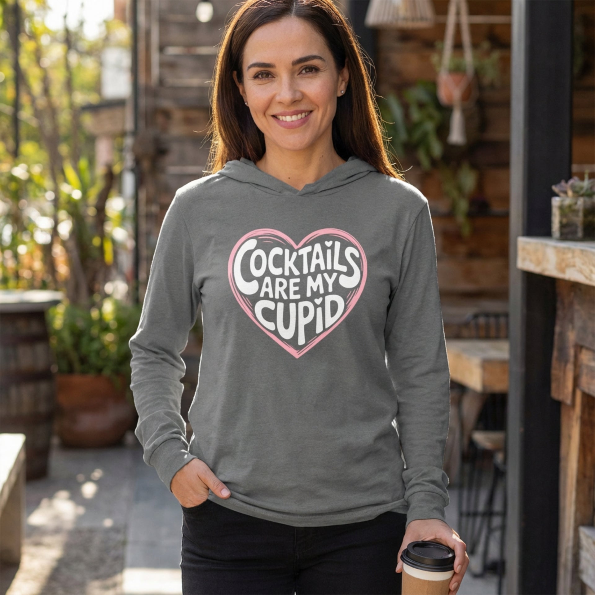 brunette model wearing grey featherweight hoodie with the phrase "Cocktails are my cupid".  A minimalist valentine heart outline surrounds the phrase to complete the design
