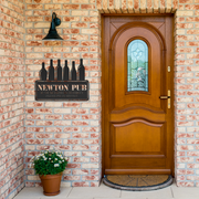 Custom_Bar_Sign__Personalized_Metal_W_Black_Brick_Entrance_Mockup.png