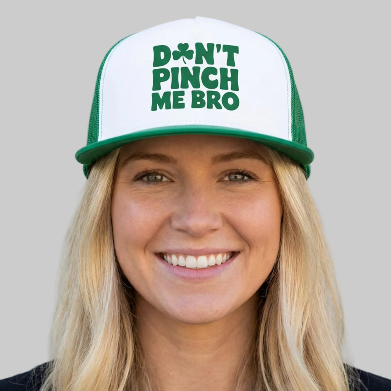 Person wearing a cap with 'Don't Pinch Me Bro' text against a plain background