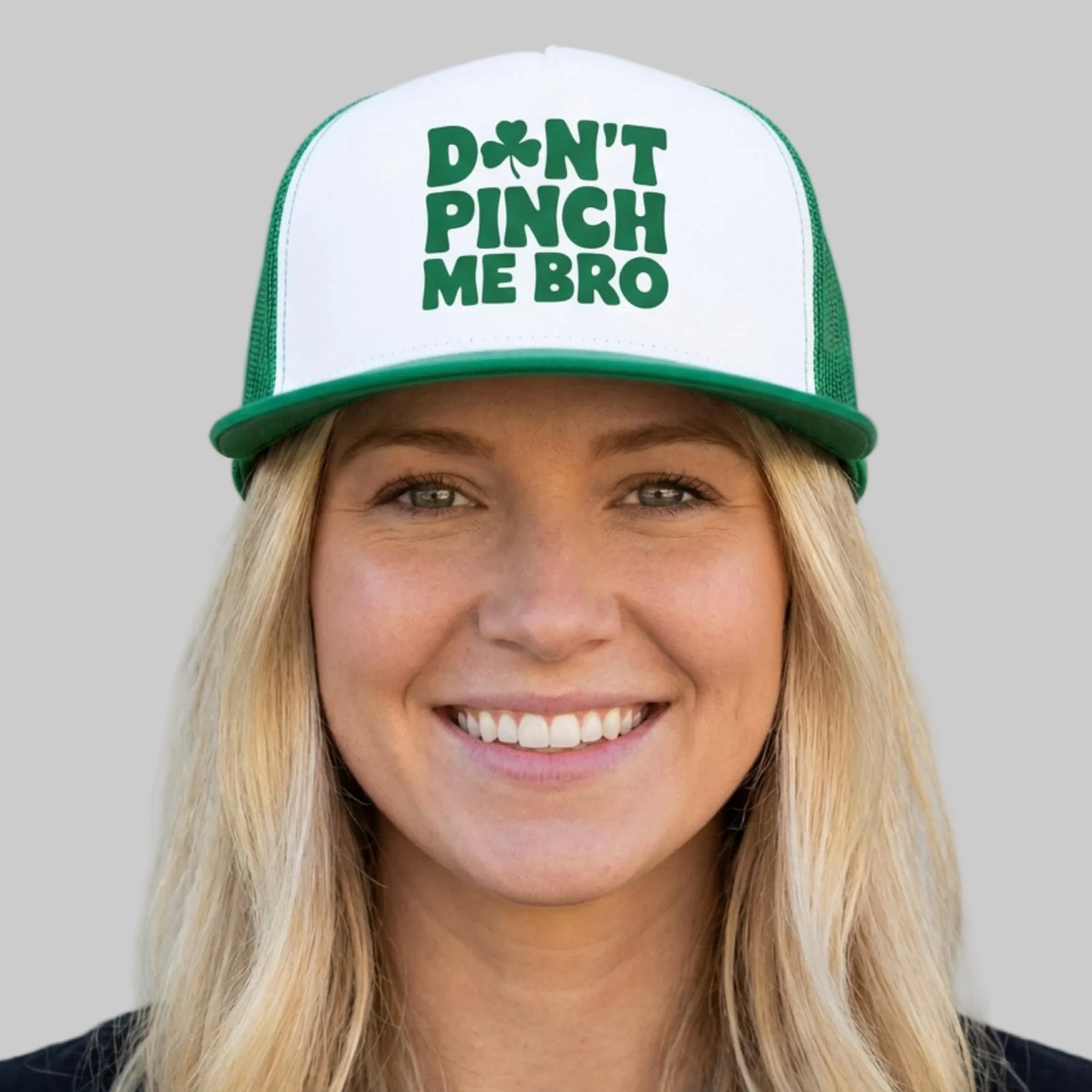 Person wearing a cap with 'Don't Pinch Me Bro' text against a plain background