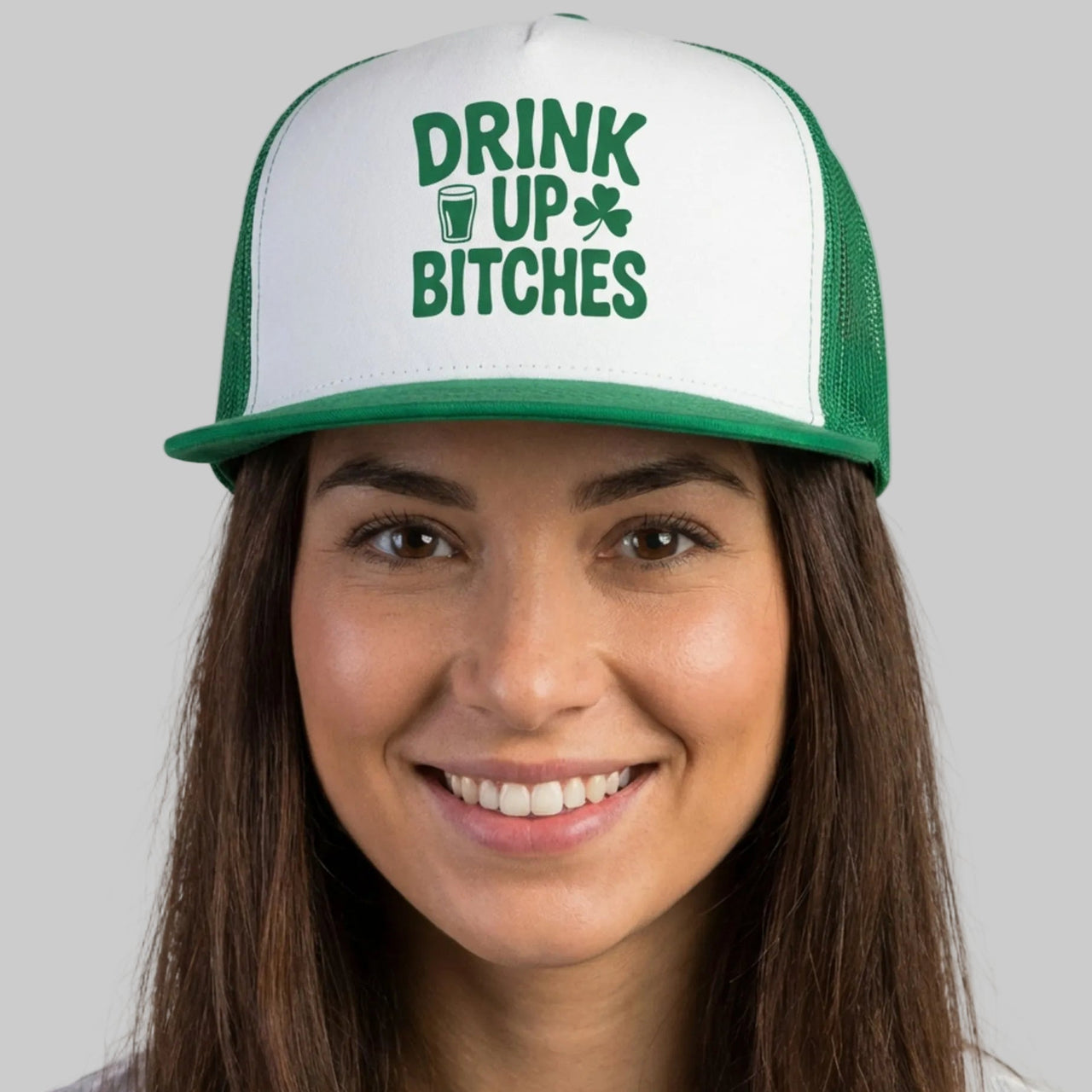 Person wearing a cap with 'Drink Up Bitches' text on a plain background