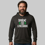 Man wearing a black hoodie with text 'Drinking until I see Leprechauns' funny st patricks day design
