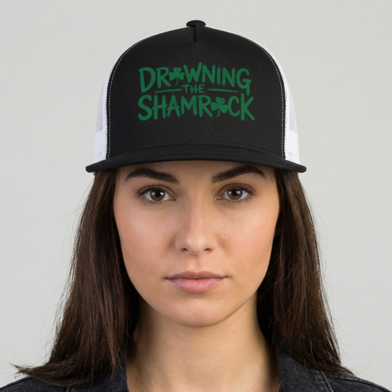 Person wearing a black and white cap with green text on a gray background