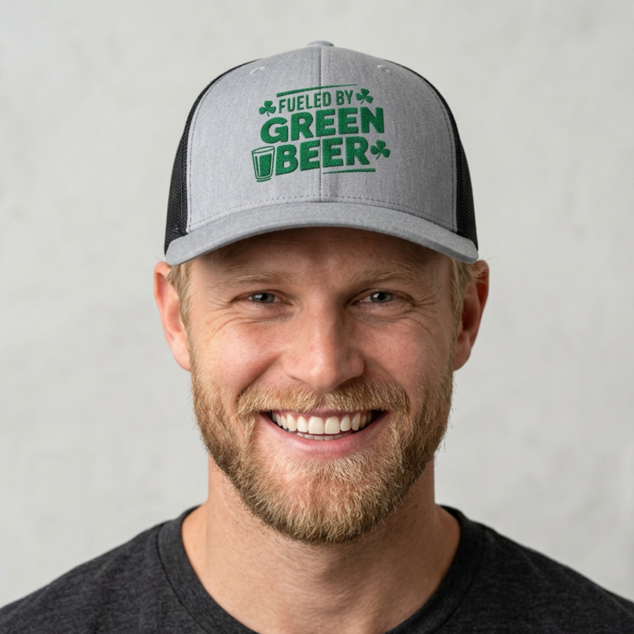 Man wearing a gray and black curved trucker hat with the phrase 'Fueled by Green Beer' funny St Patricks Day pub crawl design