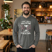 brunette bearded male model wearing Gray featherweight hoodie with the phrase “I don’t need a valentine I need a cocktail” with an ink sketched wine glass and sketched valentine hearts to  complete the design