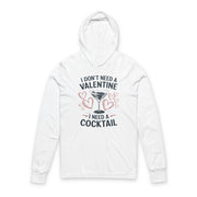 white featherweight hoodie with the phrase “I don’t need a valentine I need a cocktail” with an ink sketched wine glass and sketched valentine hearts to  complete the design