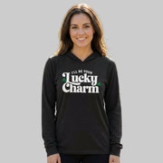brunette woman wearing a black lightweight St Patricks  Day hoodie with the Phrase “ill be your lucky charm”  with  shamrocks to complete the design