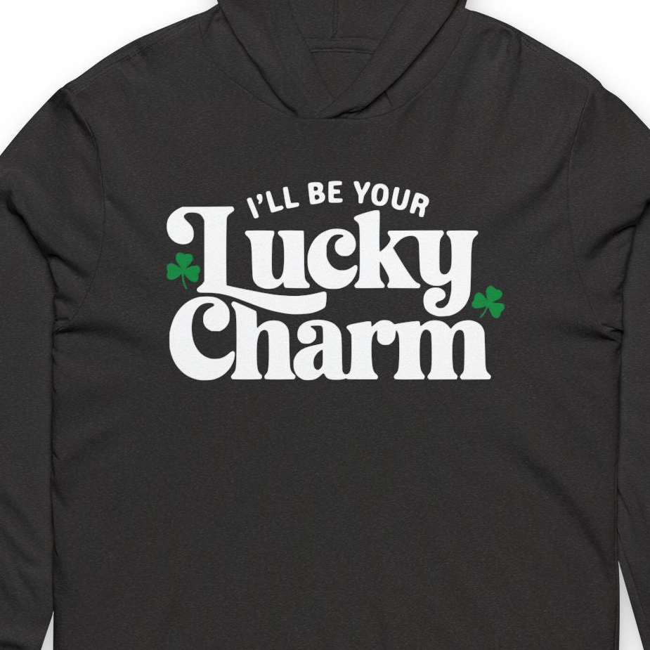 Black hoodie with 'I'll Be Your Lucky Charm' text and shamrock graphics on a white background